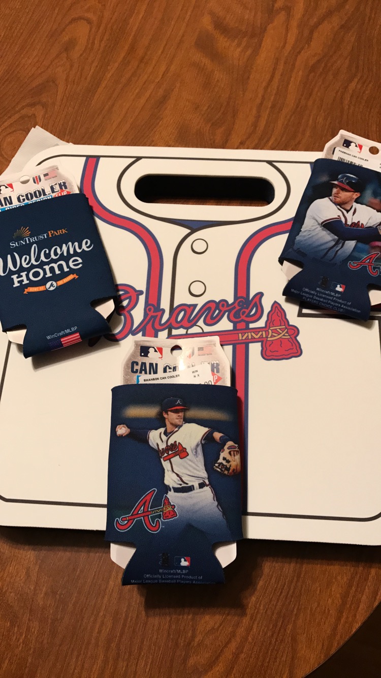 A picture of a Braves foam cushion and 3 koozies.