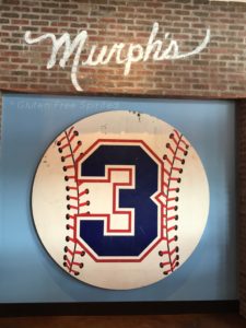 A picture of a giant baseball sign with a #3.