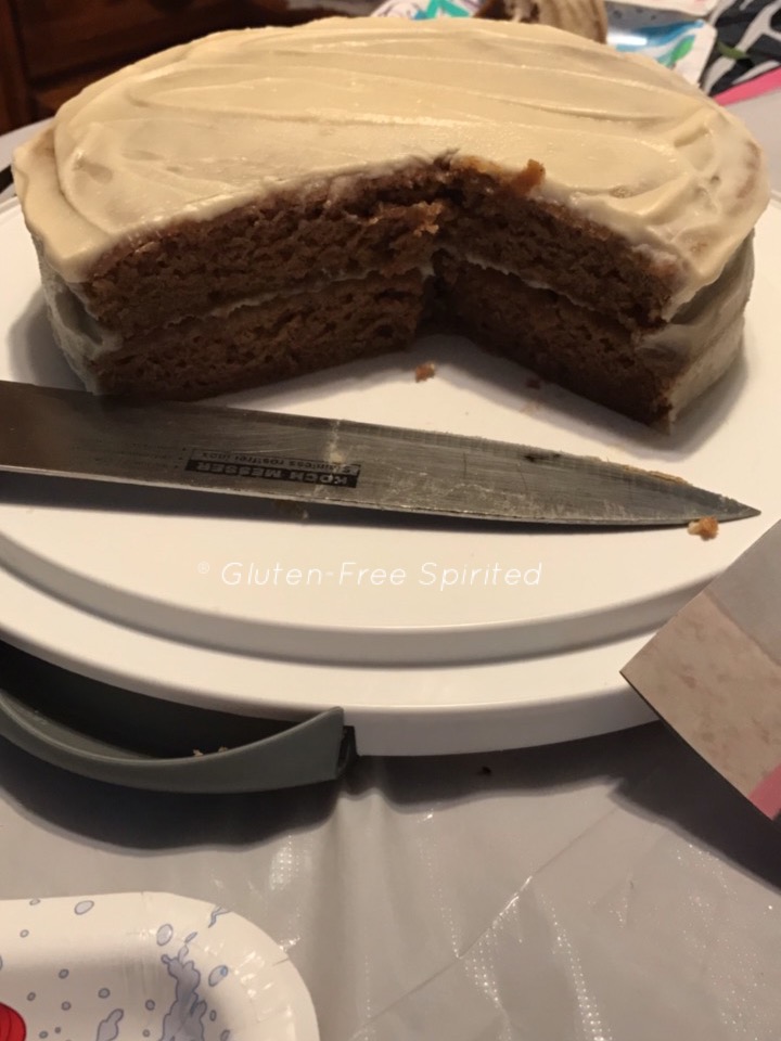 A pic of a carrot cake with slices missing. 