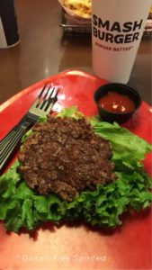 A picture of a burger on a lettuce bun at Smashburger.