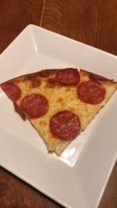 A slice of pizza from Marco's Pizza with gluten-free crust