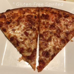 Two slices of bacon & cheese gluten-free crust pizza from Hawthorne's Pizza.