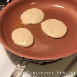 A picture of 3 cooking pancakes.