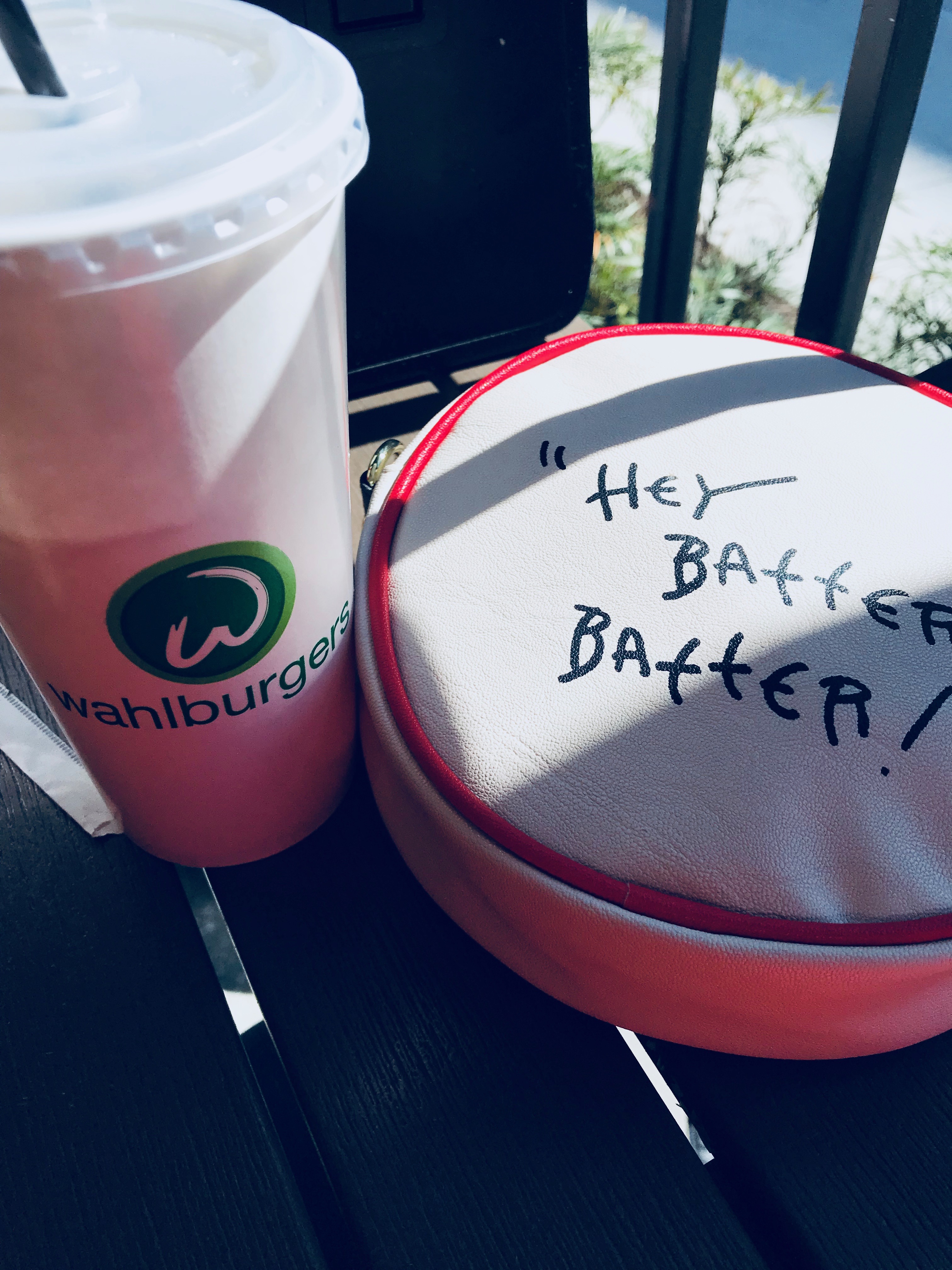 Wahlburgers cup and baseball purse