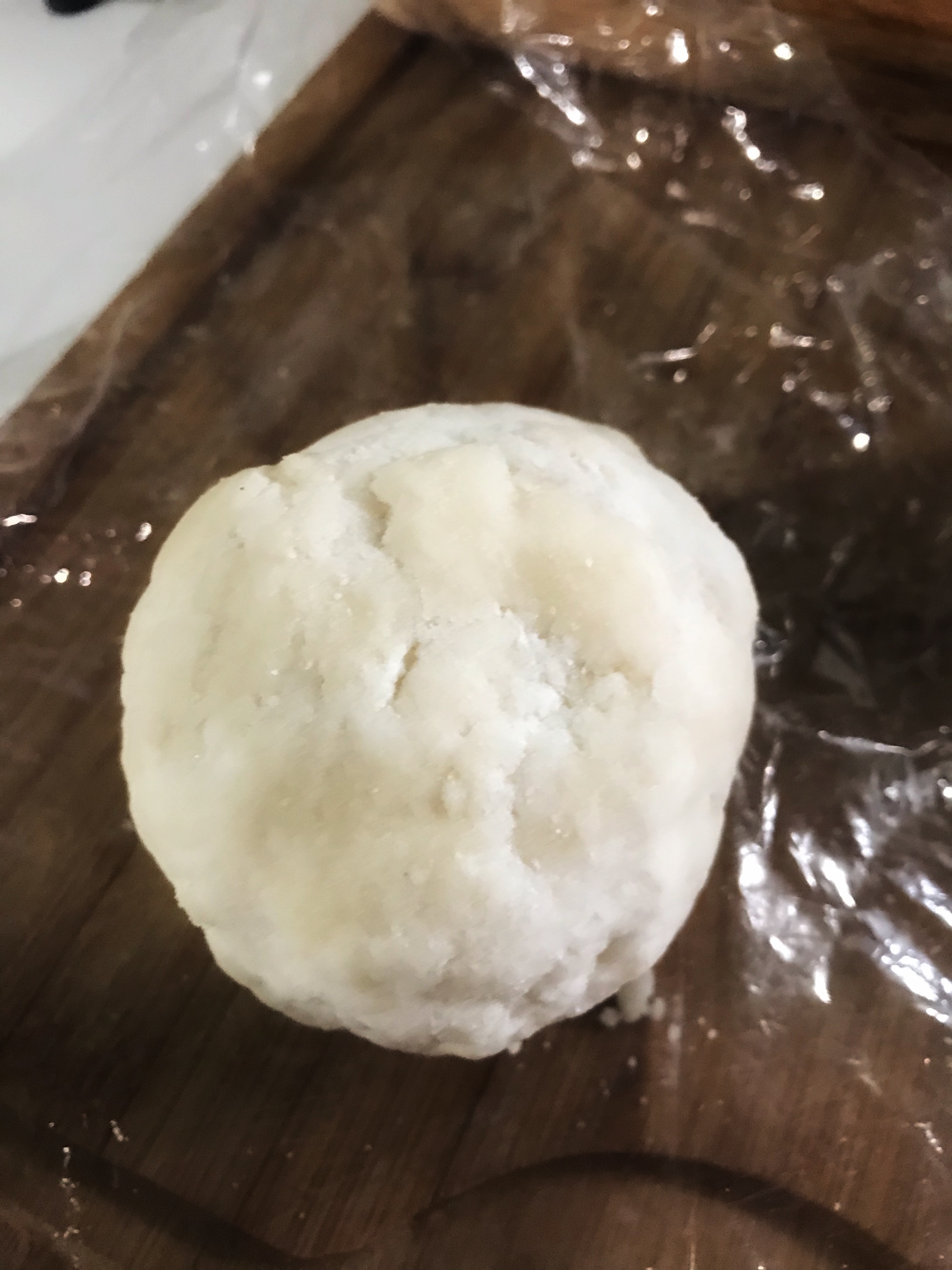 Pie crust ball on plastic wrap