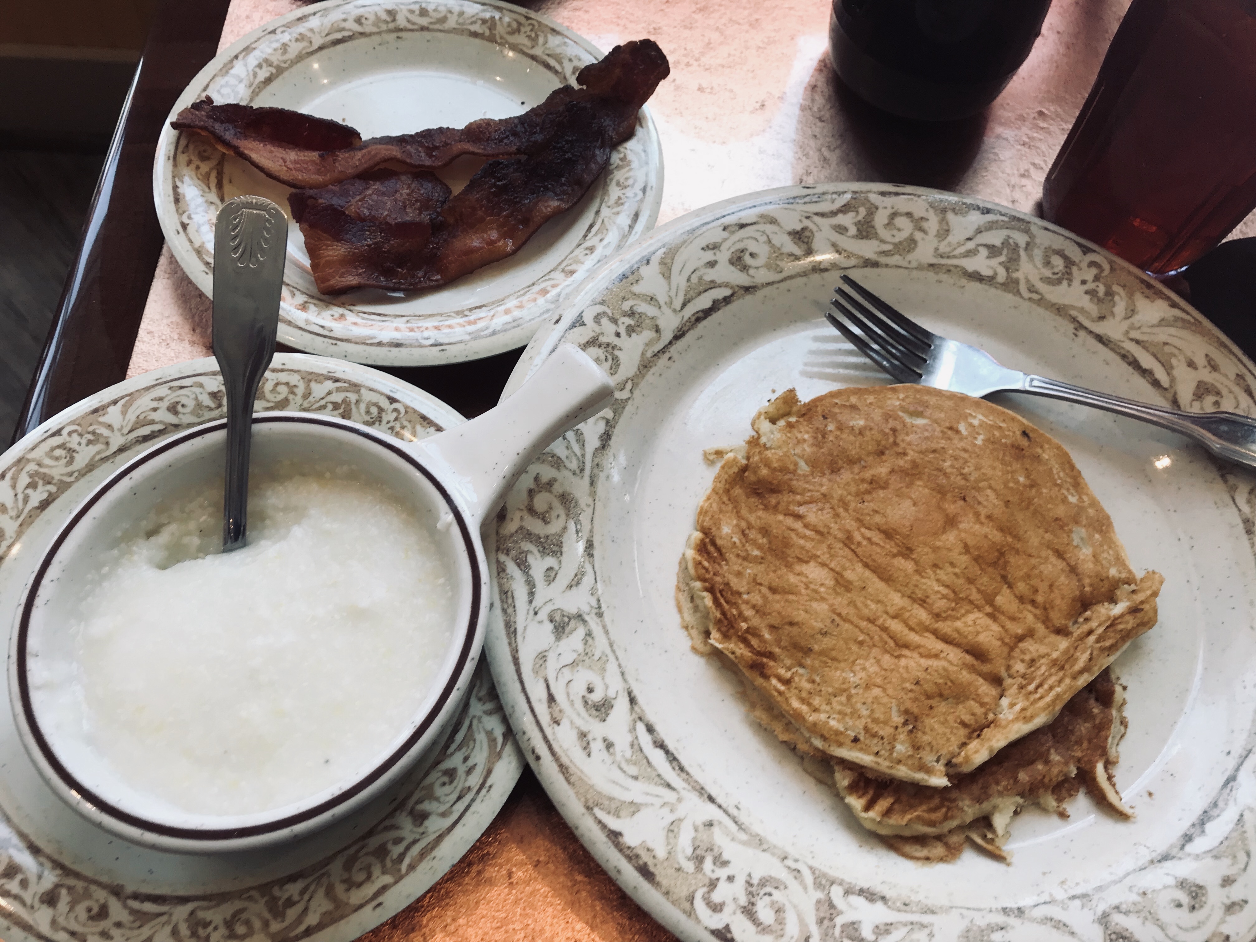 Pancakes, grits, & bacon from Another Broken Cafe