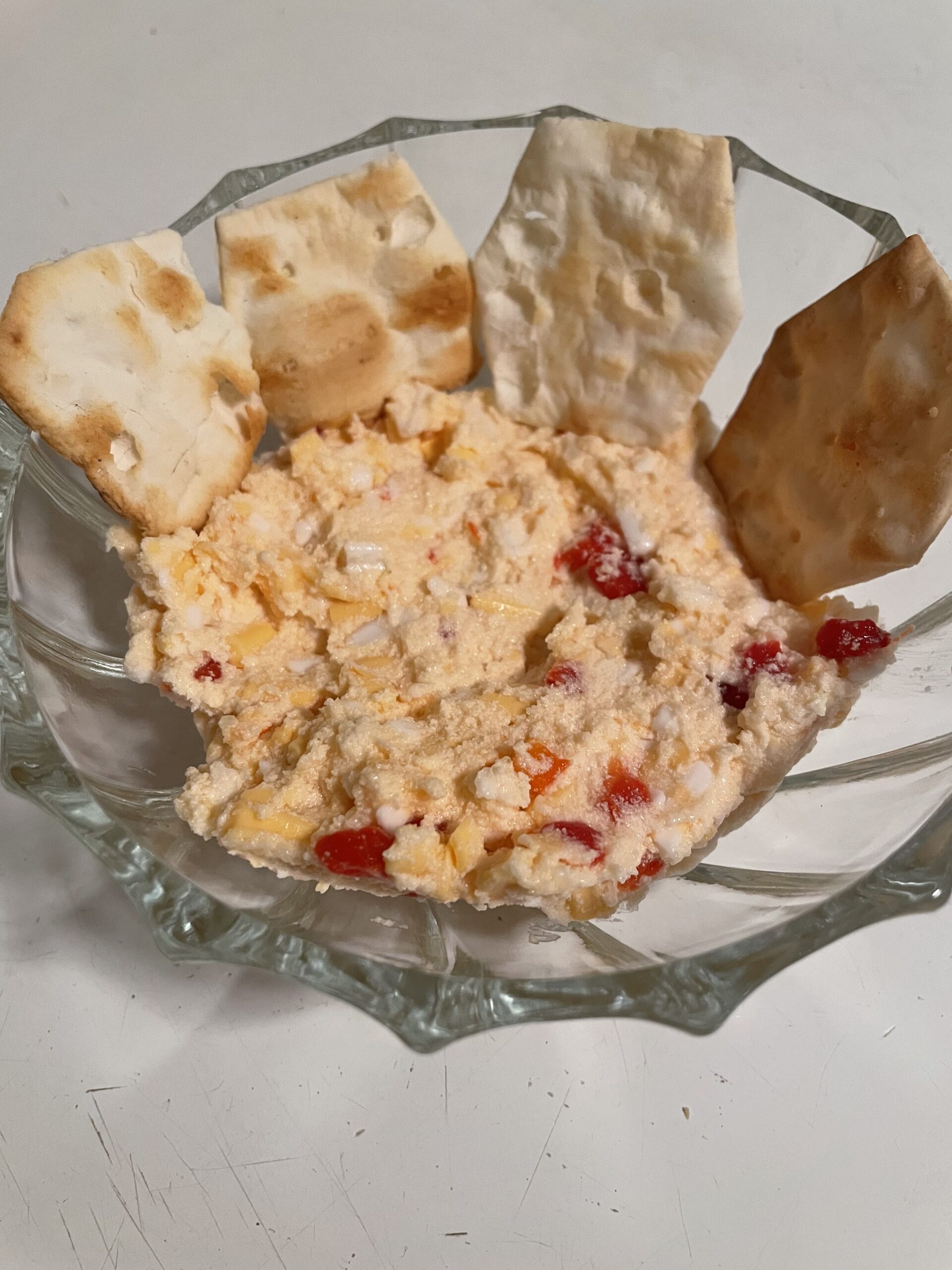 Pimento cheese in a bowl with crackers